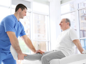 a nurse helping his patient exercise