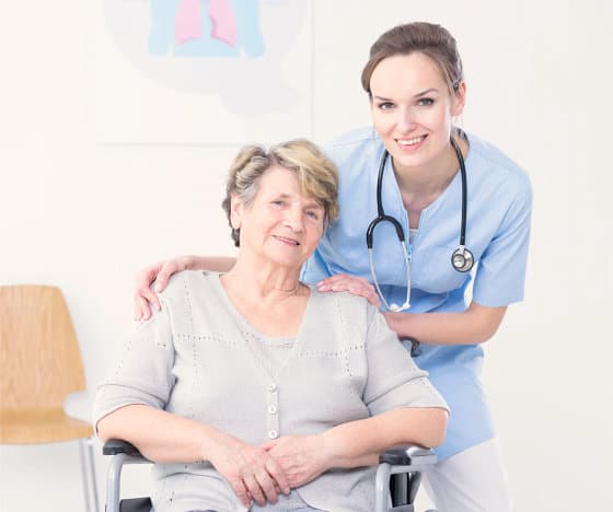 a nurse and an elderly patient smiling