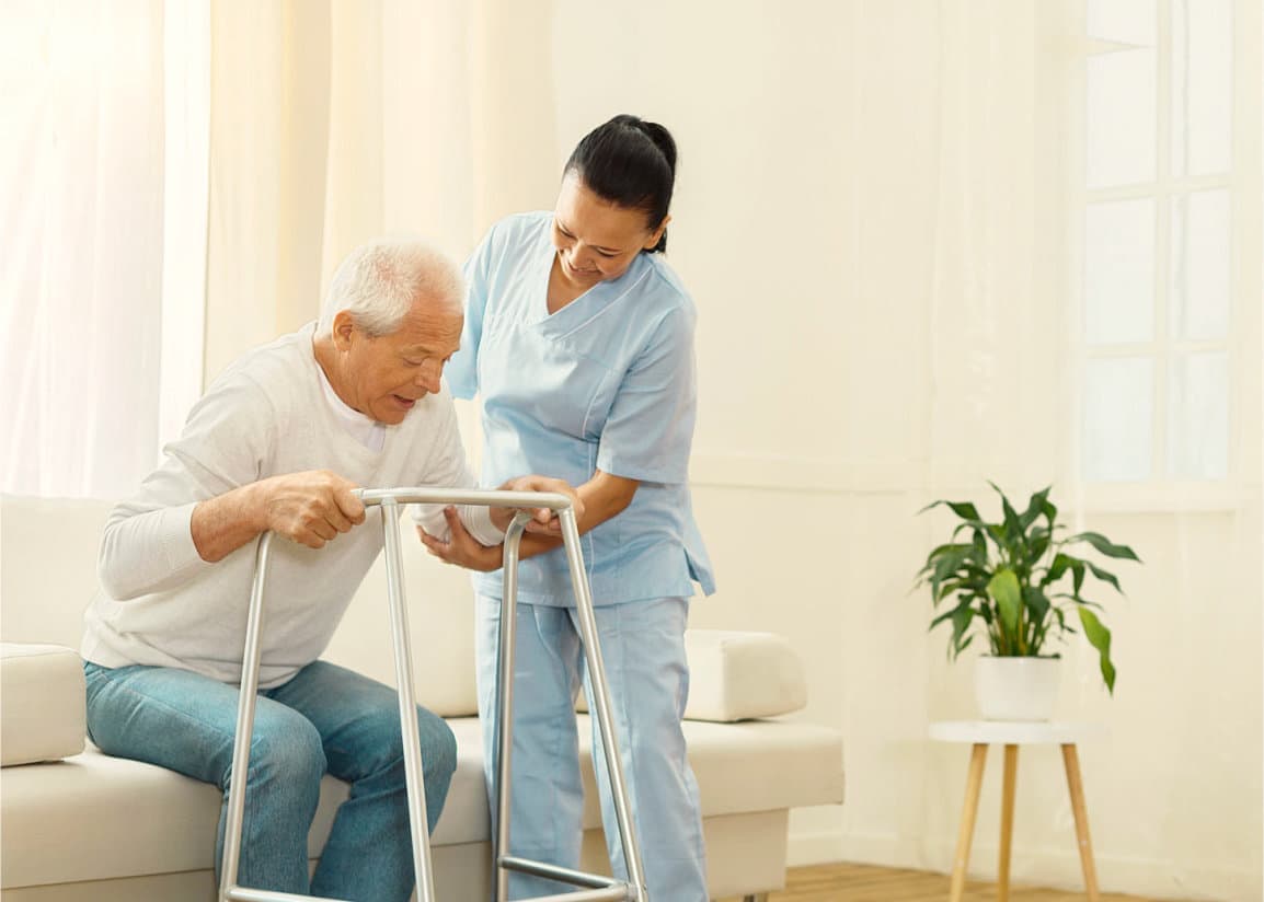 a nurse assisting her patient standing up